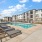 Pet-Friendly Apartments in Modesto, CA - Kinsley Yard - Pool with Yellow Umbrella Tables, Lounge Chairs, and Jacuzzi